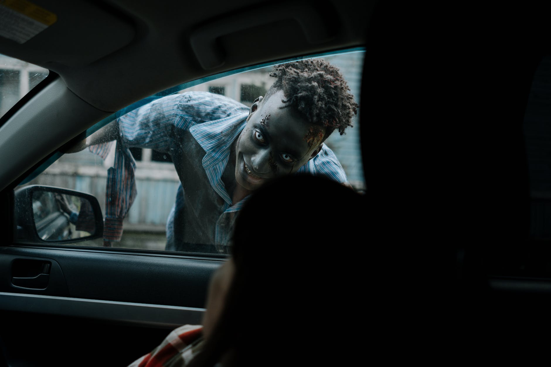 How to start writing a Horror Story - zombie peeking through a car