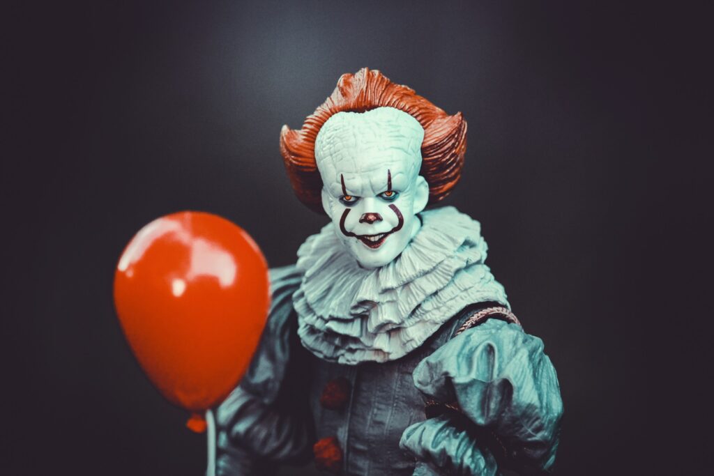 Pennywise the clown with a red balloon.